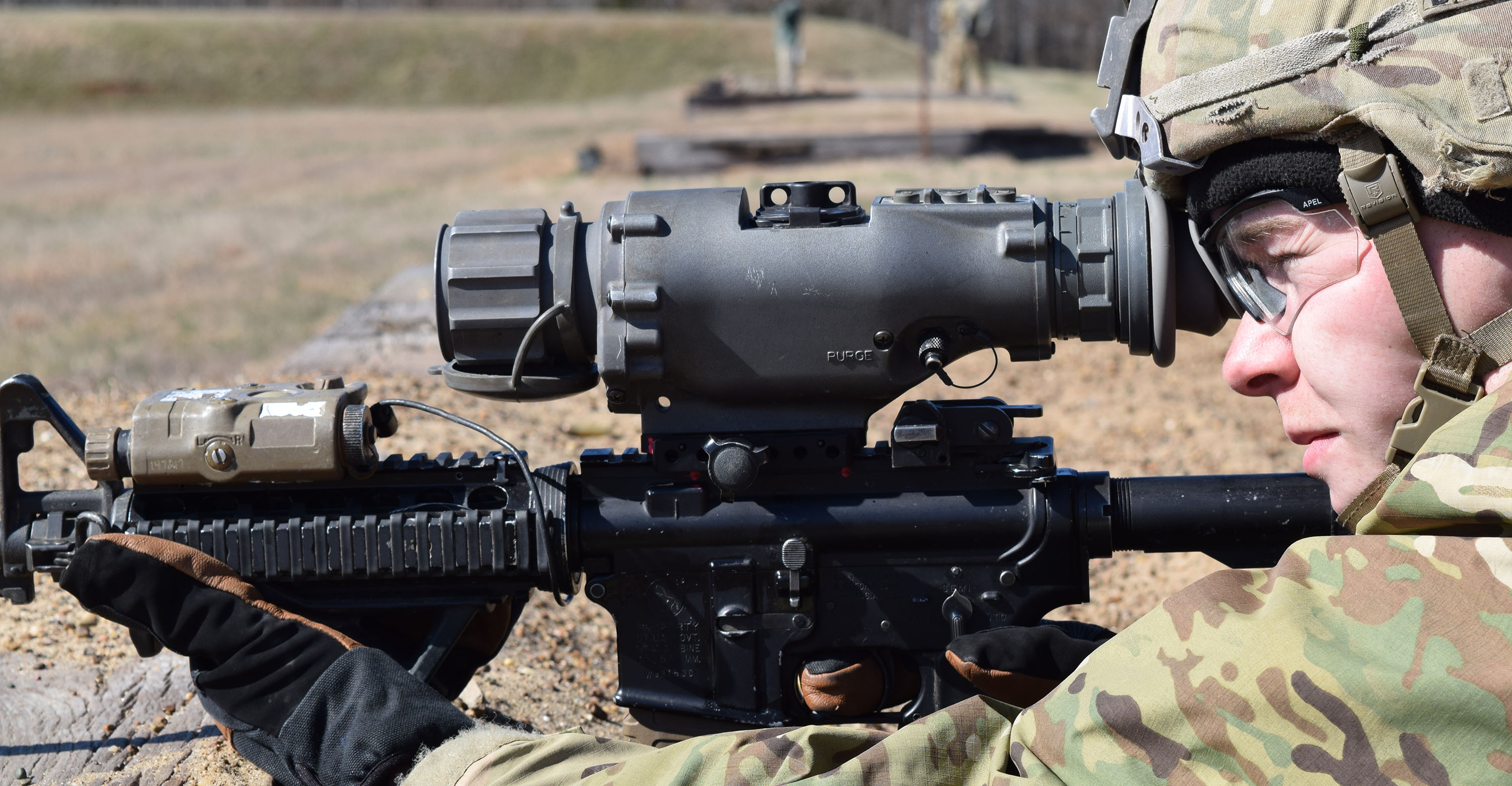 A military personnel looks through a thermal weapon sight during a training exercise.