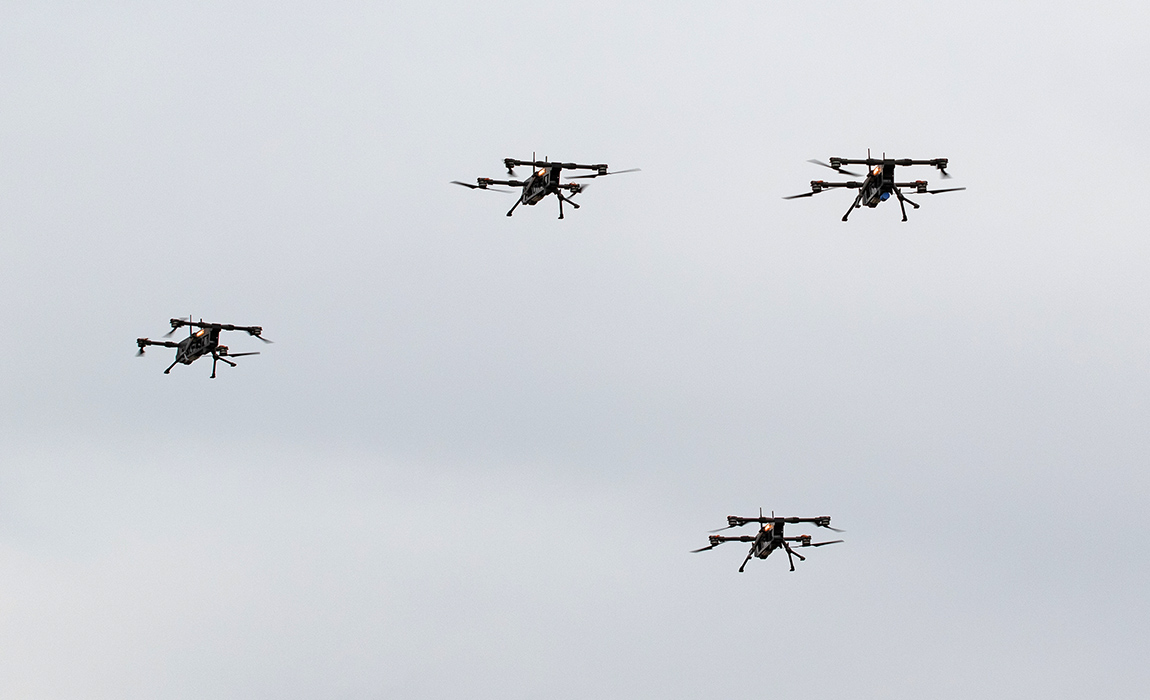 Four drones flying in the sky during a training exercise, showcasing advanced technology and precision aerial maneuvers.