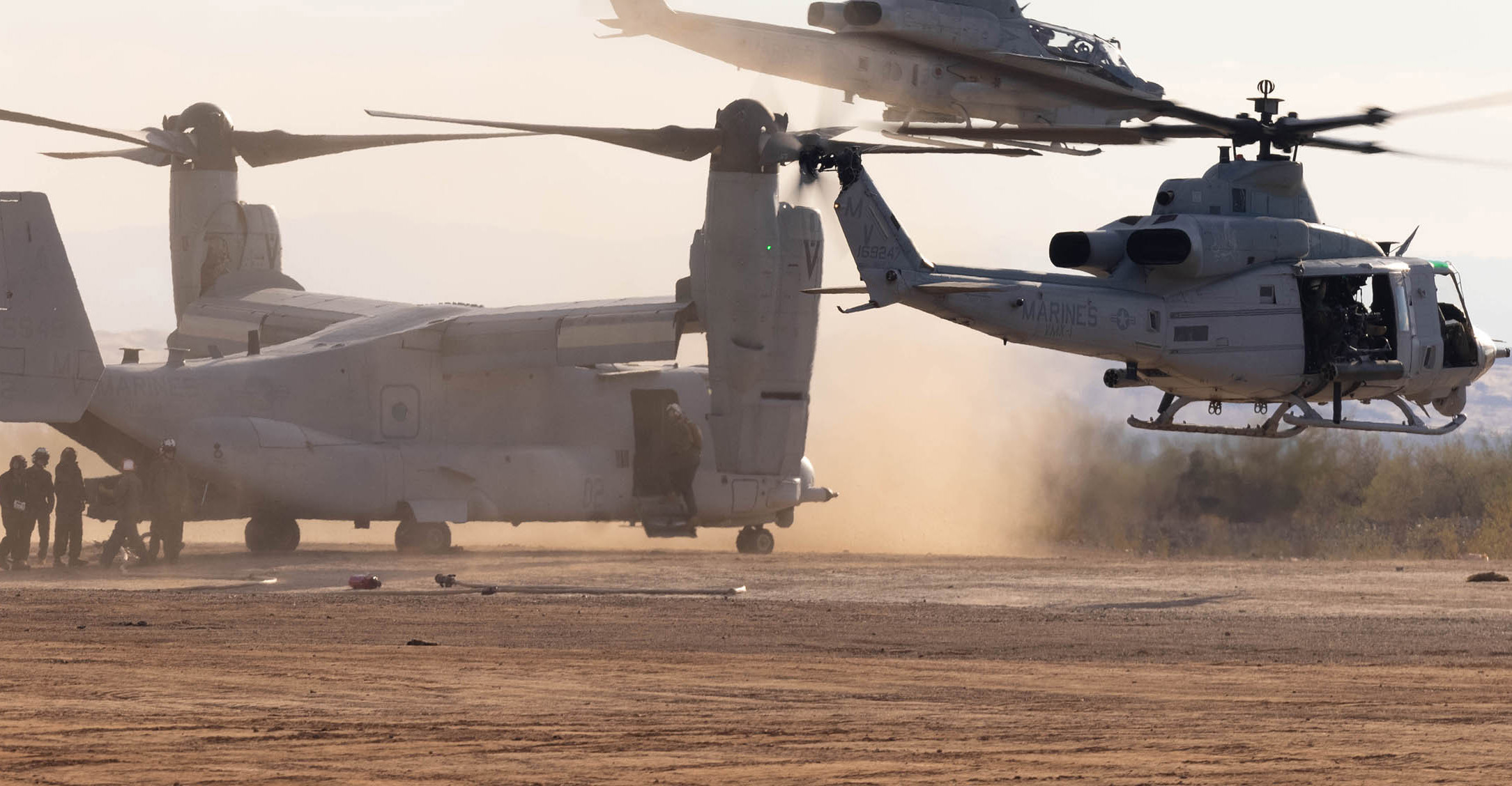 A group of soldiers loading into a helicopter .