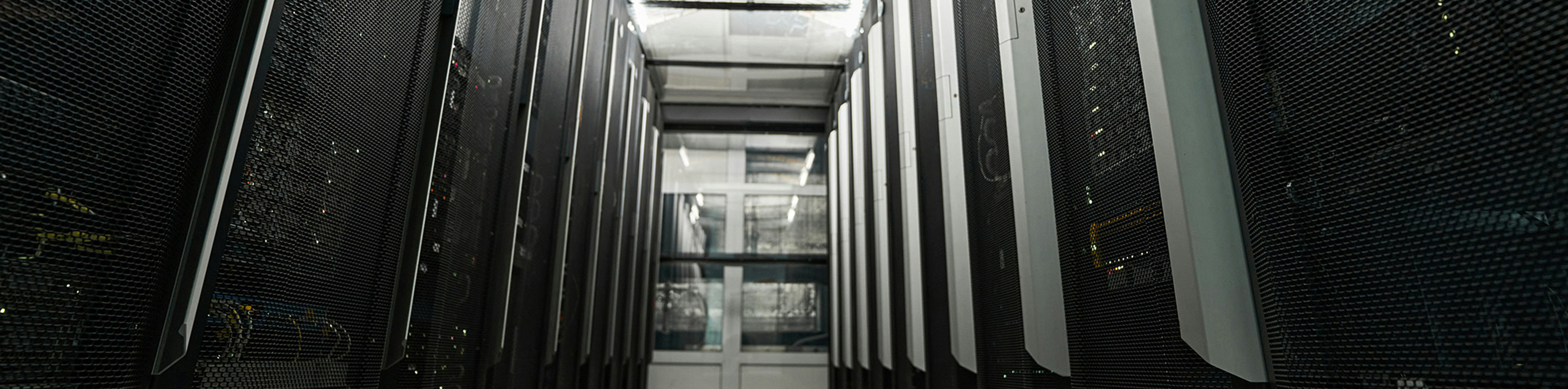 A long hallway lined with numerous servers, showcasing a high-tech data center environment.