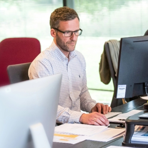 A man working at a computer.