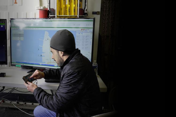 A man focused on two monitors.