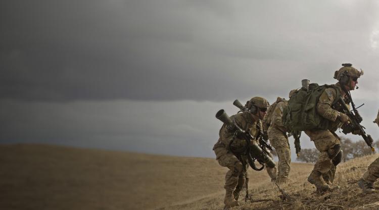 U.S. Army Rangers climb into position on a hillside during a training exercise.