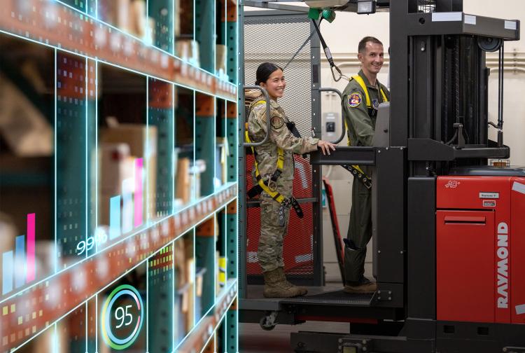 Airmen working in warehouse with high tech analytics